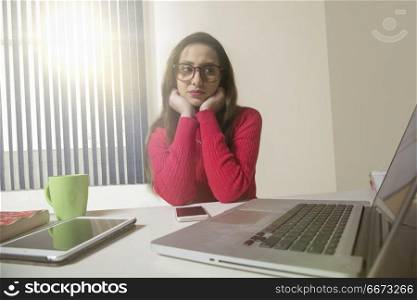 Tired businesswoman looking at laptop