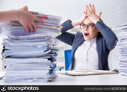 Tired businesswoman with paperwork workload