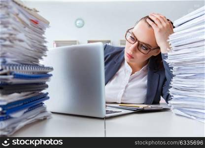 Tired businesswoman with paperwork workload
