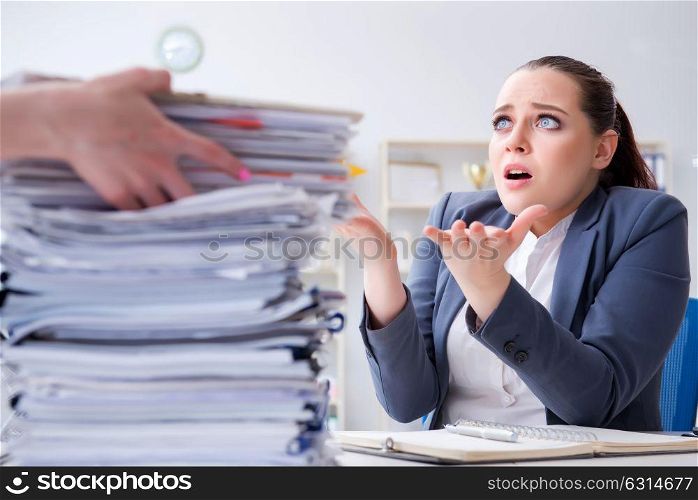 Tired businesswoman with paperwork workload. The tired businesswoman with paperwork workload