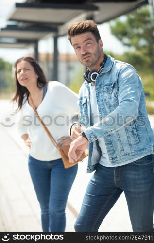 tired couple at train station