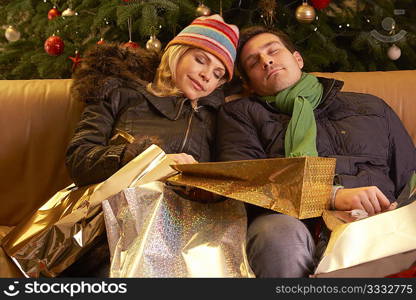 Tired Couple Returning After Christmas Shopping Trip