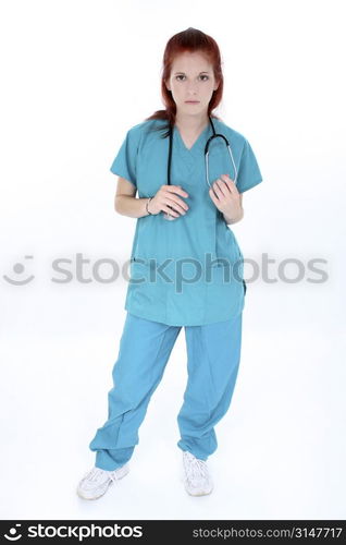 Tired emergency room nurse standing over white. Young woman in teal scrubs with stethoscope.