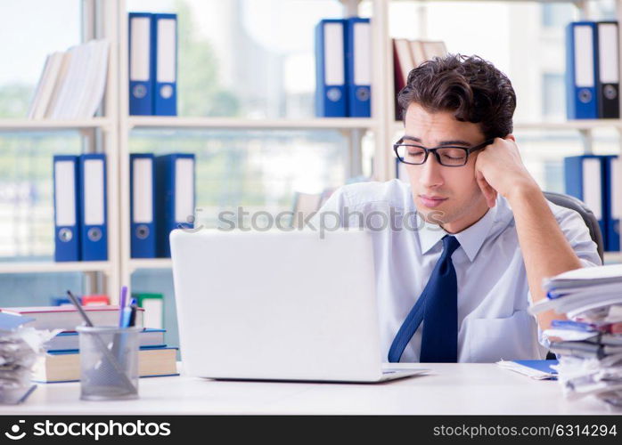 Tired exhausted businessman sitting in the office