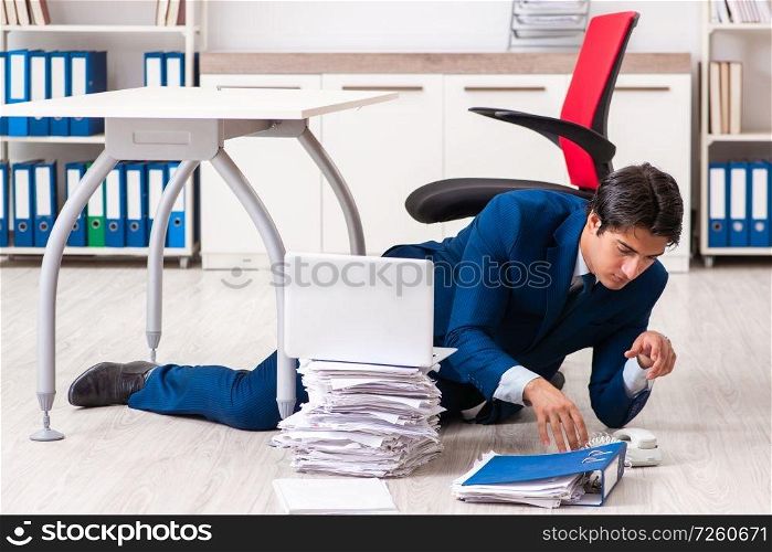 Tired exhausted businessman working overtime in office