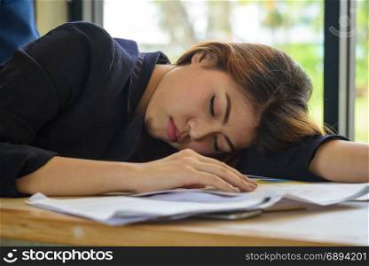 tired exhausted young asian woman sleeping in meeting room at office