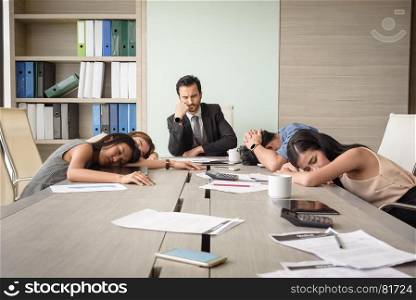 tired exhausted young business man and woman sleeping in meeting room at office