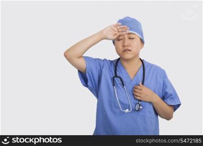 Tired female doctor with stethoscope around neck in hospital