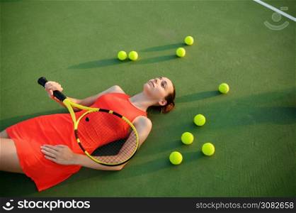 Tired female tennis player with racket lies on outdoor court. Active healthy lifestyle, sport game competition, hard fitness training with racquet. Tired female tennis player lies on court