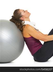 Tired fitness young woman sitting near fitness ball