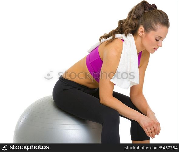 Tired fitness young woman sitting on fitness ball