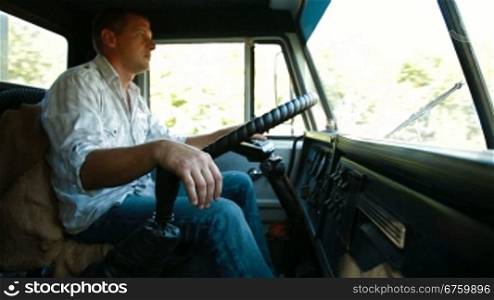 Tired lorry driver at the wheel of truck