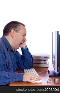 Tired man yawning at his computer