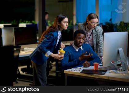 Tired managers talks in night office. Sleepy male and female workers, dark business center interior on background, modern workplace. Tired managers talks in night office