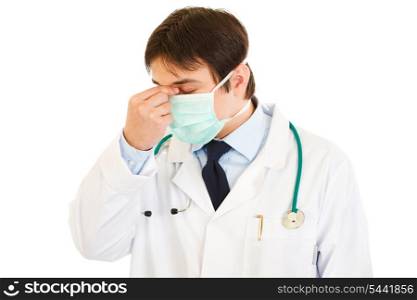 Tired medical doctor with mask on face isolated on white&#xA;