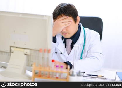 Tired medical doctor working on computer at office&#xA;