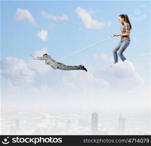 Tired of work. Woman holding on lace businessman trying to escape