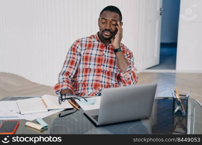 Tired online teacher. Exhausted afro man has online conference on pc. Sleepy businessman sitting with his eyes closed. Teacher is speaking to student. Remote study, distance learning. Online courses.. Tired online teacher. Exhausted afro man sleepy bsinessman sitting with his eyes closed.