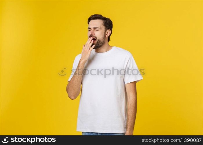 Tired or bored Caucasian hipster young man covering mouth while yawning, feeling exhausted after hard day at work. Tired or bored Caucasian hipster young man covering mouth while yawning, feeling exhausted after hard day at work.