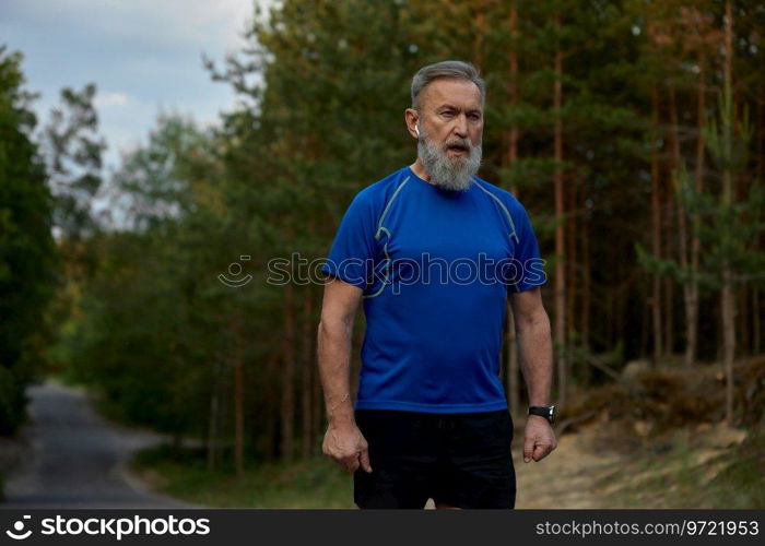 Tired retired sportsman breathing hard after jogging exercise. Sport training outdoors and everyday running activity for healthcare on retirement motivation. Tired retired sportsman breathing hard after jogging exercise