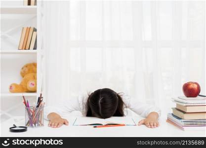 tired schoolgirl lying copybook