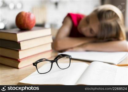 tired schoolgirl sleeping desk
