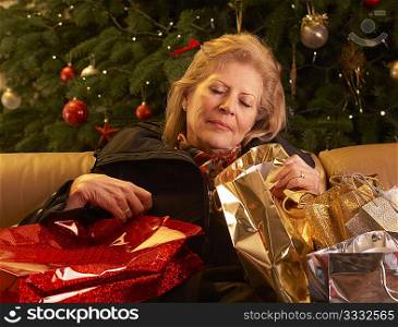 Tired Senior Woman Returning After Christmas Shopping Trip