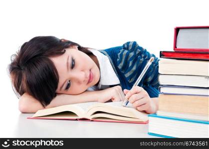 Tired student resting on her arm while reading