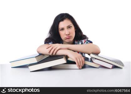 Tired student with textbooks on white