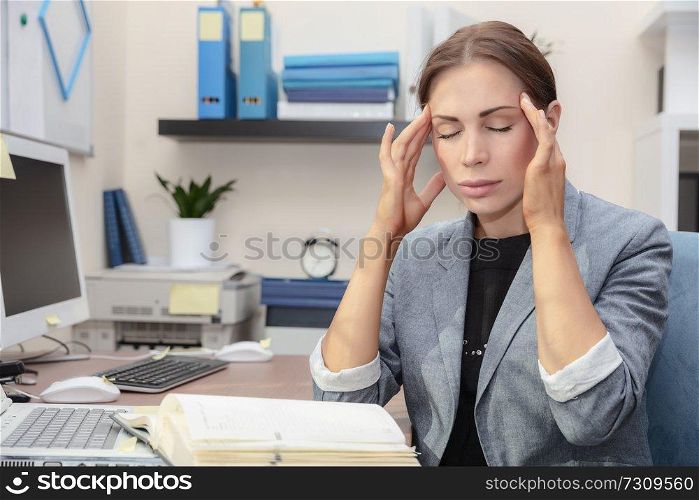 Tired woman at work, beautiful businesswoman in the office suffers of headache, problems with documents, hard office work concept