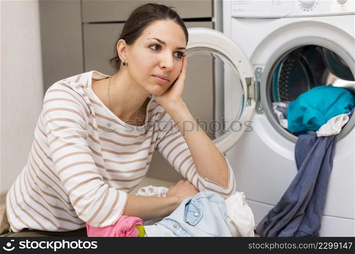 tired woman doing laundry