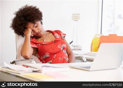 Tired Woman Working At Desk In Design Studio