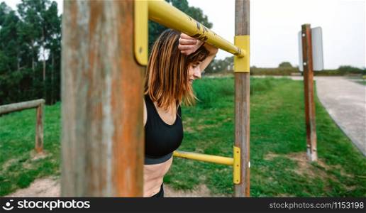 Tired young athlete woman after training outdoors. Tired athlete woman after training