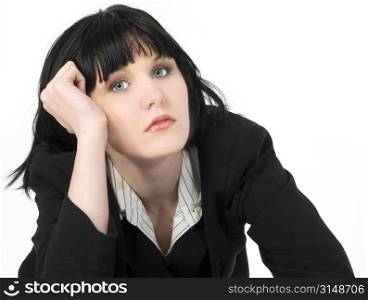 Tired young business woman leaning on hand.