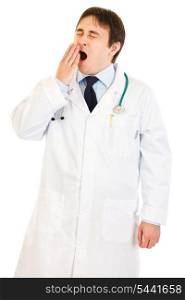 Tired young medical doctor yawning isolated on white&#xA;