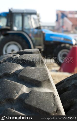 Tires for trucks and tractors. Traktors on background