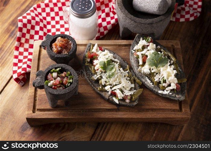 Tlacoyos with Nopales and Cheese. Mexican pre hispanic dish made of blue corn flour patty filled with refried beans. Popular street food in Mexico.