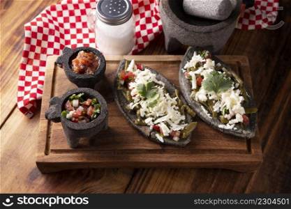 Tlacoyos with Nopales and Cheese. Mexican pre hispanic dish made of blue corn flour patty filled with refried beans. Popular street food in Mexico.