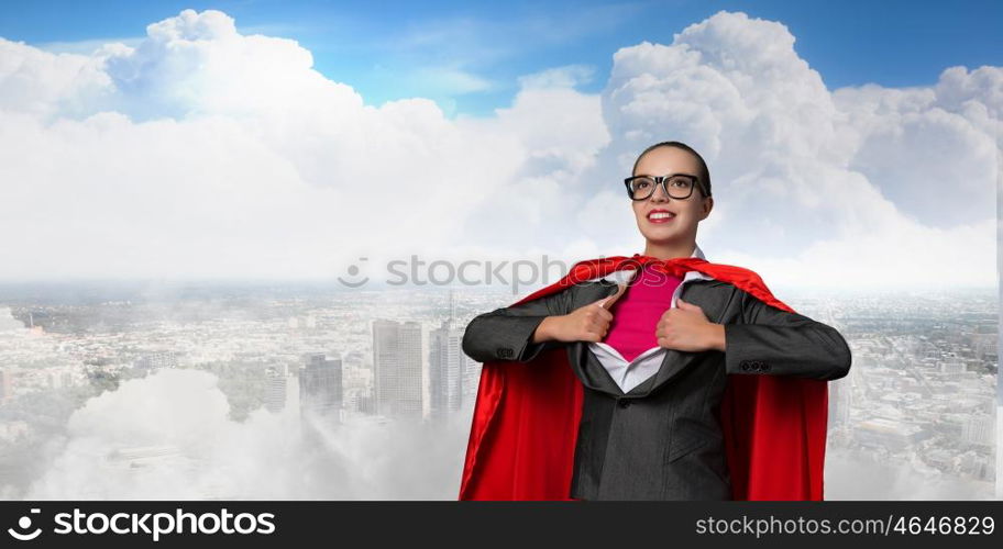 To be super woman takes strength. Businesswoman wearing red cape and opening her shirt like superhero