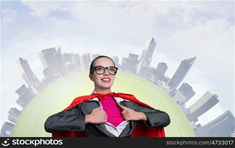 To be super woman takes strength. Businesswoman wearing red cape and opening her shirt like superhero