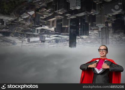 To be super woman takes strength. Businesswoman wearing red cape and opening her shirt like superhero