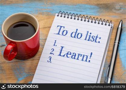 To do list in a spiral notebook - learn - with a cup of coffee, goal setting and education concept