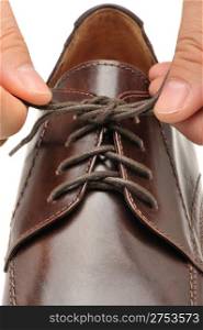 To fasten bootlace on shoes. A photo close up