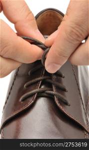 To fasten bootlace on shoes. A photo close up