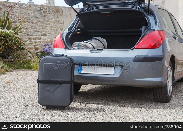 To put the suitcase in the boot of a car before traveling