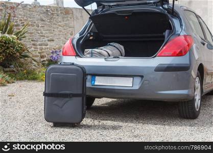 To put the suitcase in the boot of a car before traveling