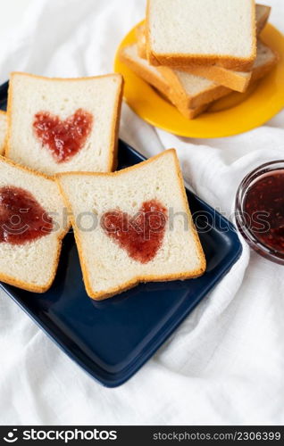 Toast on which the heart is made of jam. Surprise breakfast concept in bed. Romance for St. Valentine&rsquo;s Day. Toast on which the heart is made of jam. Surprise breakfast concept in bed. Romance for St. Valentine&rsquo;s Day.