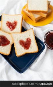 Toast on which the heart is made of jam. Surprise breakfast concept in bed. Romance for St. Valentine&rsquo;s Day. Toast on which the heart is made of jam. Surprise breakfast concept in bed. Romance for St. Valentine&rsquo;s Day.