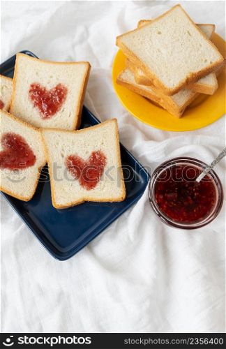 Toast on which the heart is made of jam. Surprise breakfast concept in bed. Romance for St. Valentine&rsquo;s Day. Toast on which the heart is made of jam. Surprise breakfast concept in bed. Romance for St. Valentine&rsquo;s Day.