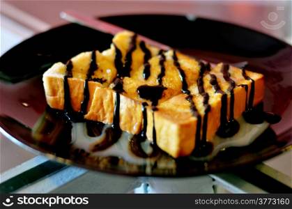 Toast topped with sweetened condensed milk and chocolate sauce